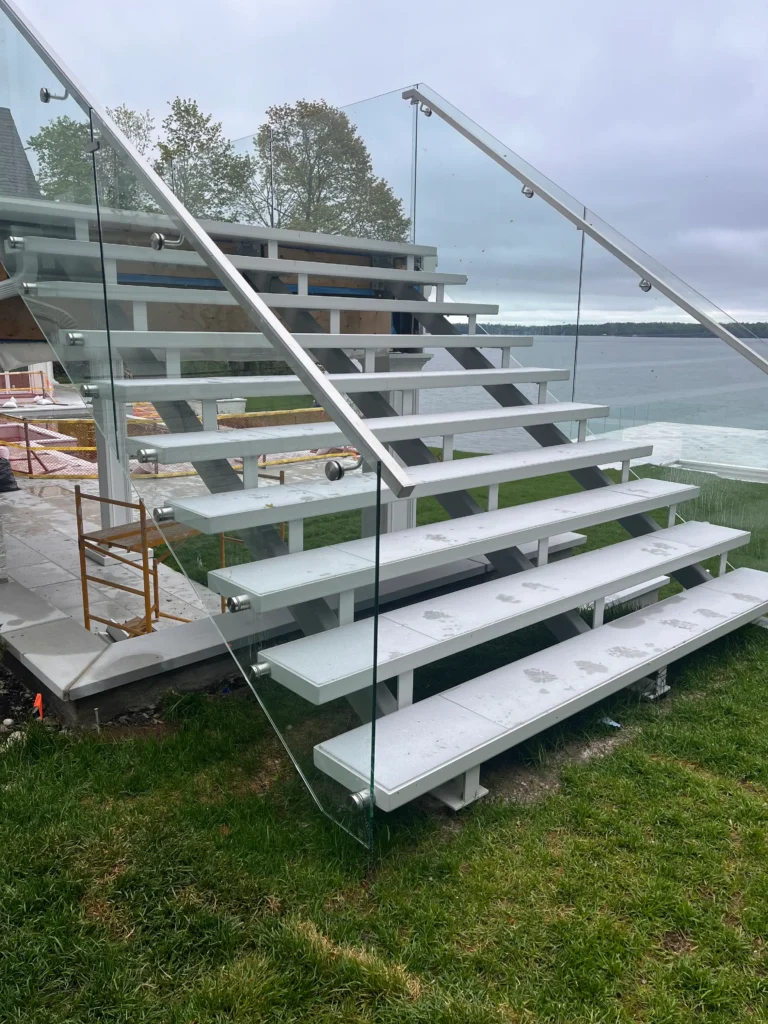 Exterior steel staircase with open treads and glass railings