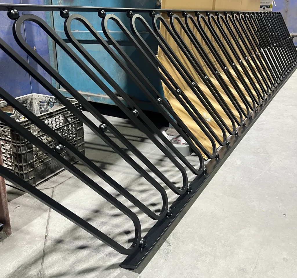 Black ornamental metal railing with decorative scrollwork