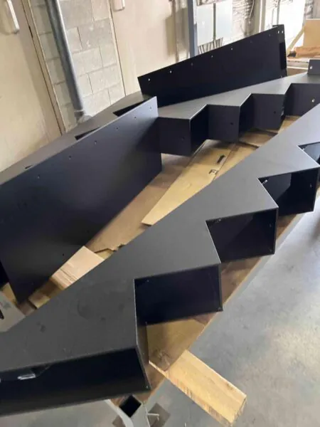 Fabricated steel stair stringers in a workshop