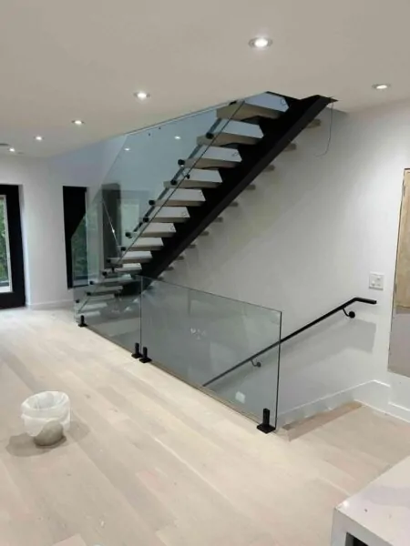 Custom open riser steel staircase with wood treads and glass railings