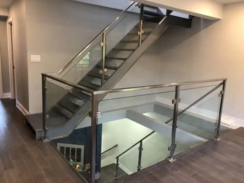 Modern interior staircase with glass railing by Modern Stairs Plus