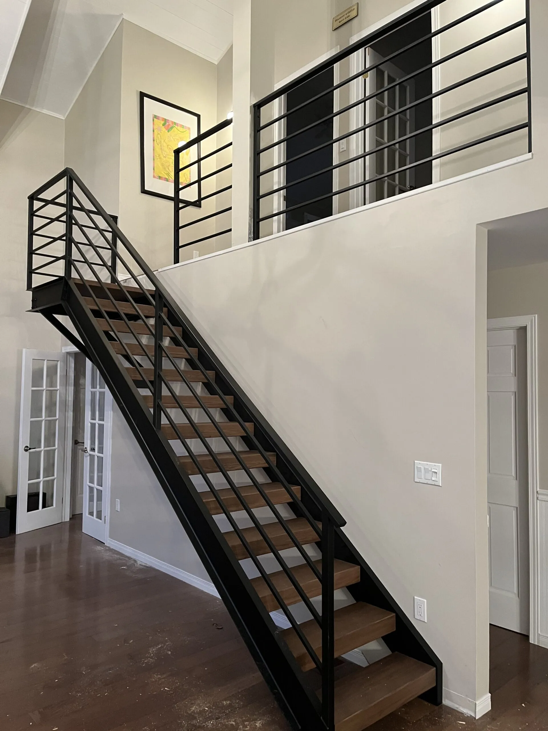 Sleek modern horizontal bar metal railing system installed on a balcony or staircase with evenly spaced metal bars.
