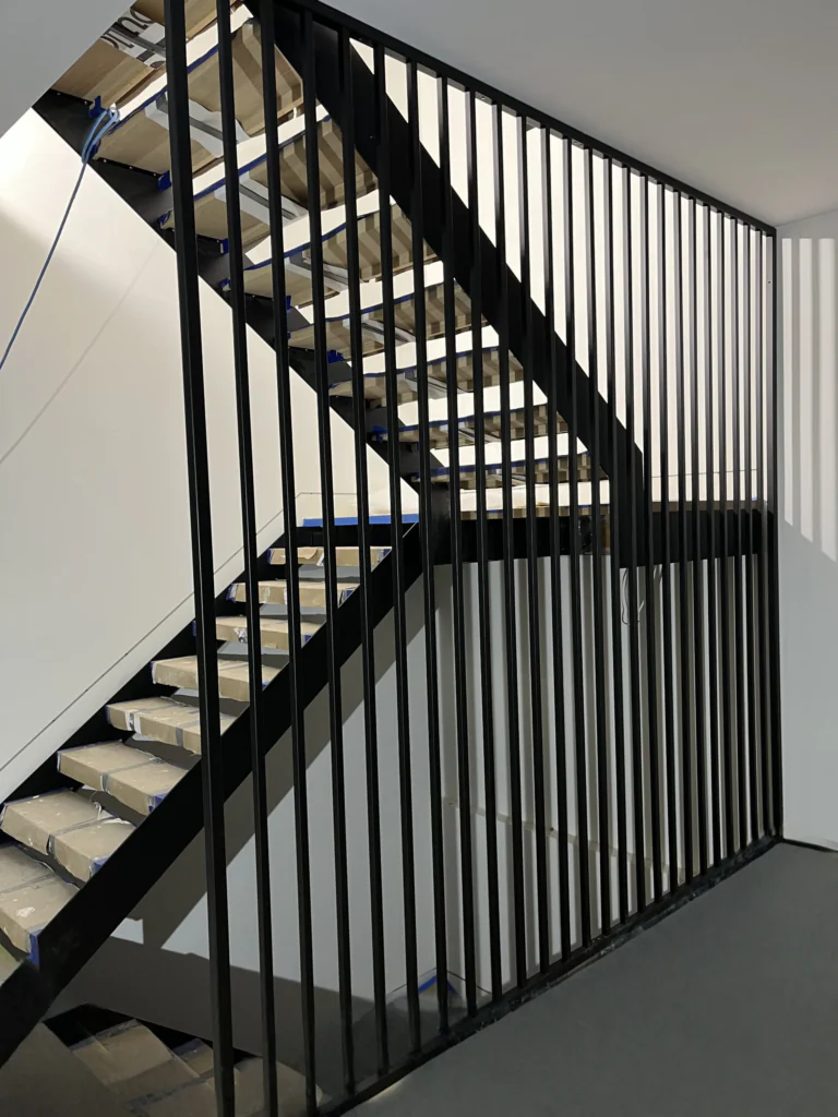Double-stringer stairs with modern metal railings