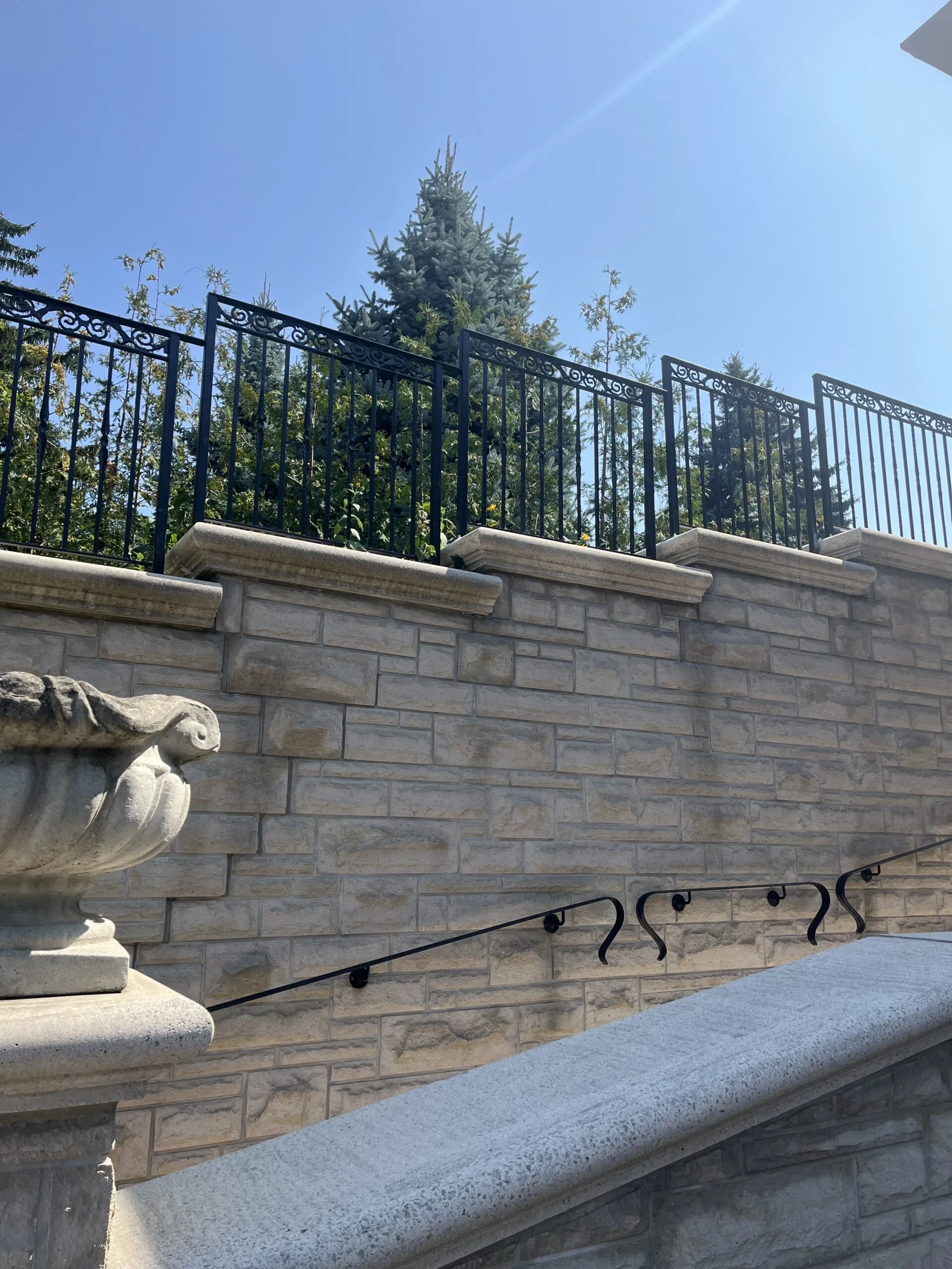 Sleek modern metal fence panels installed along a property boundary for security and privacy.